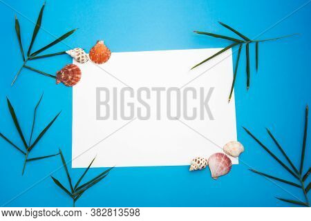 Blank Paper Concept For Text With Frames Adorned With Bamboo Leaves,shell And Blue Paper Background.