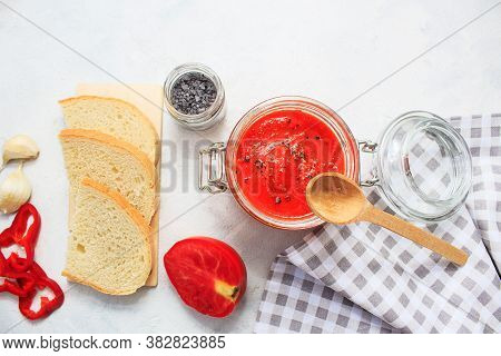 Ajvar, Pepper Mousse In A Jar And On  Bread And Wooden  Spoon On Backgground. Ajvar - Delicious Dish