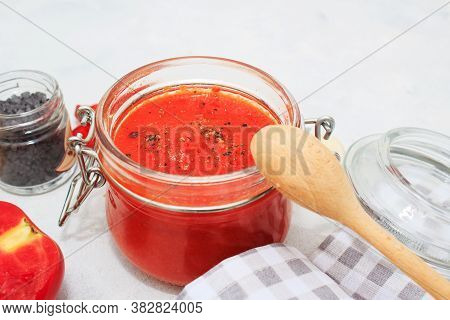 Ajvar, Pepper Mousse In A Jar And On  Bread And Wooden  Spoon On Backgground. Ajvar - Delicious Dish