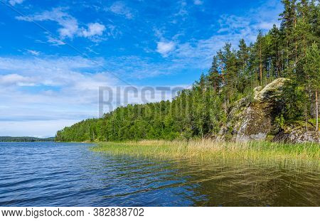 The Rocky Coastline Of The Lake Ladoga Overgrew The Pines. Karelia, Russia.