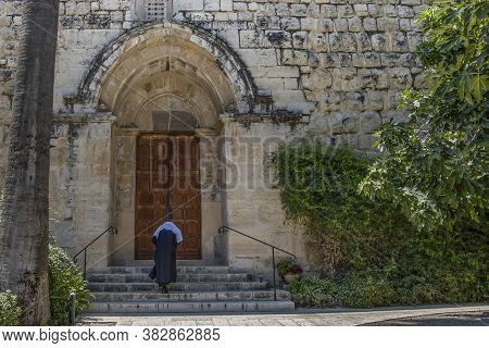 Abu Ghosh, Israel - August 13th, 2020: A Nun Entering The Crusader Church In The Arab Village Abu Gh