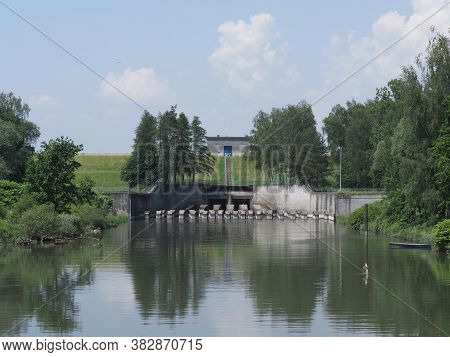 Building Of Dam Reflected In Waters Of Pond In European Goczalkowice Town At Silesian District In Po