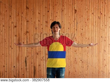 Man Wearing United States Minor Outlying Islands Flag Color Shirt And Standing With Arms Wide Open O