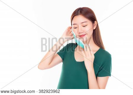 Beautiful Young Asian Woman Taking Off Protective Face Mask Or Wearing Disposable Face Mask. Protect