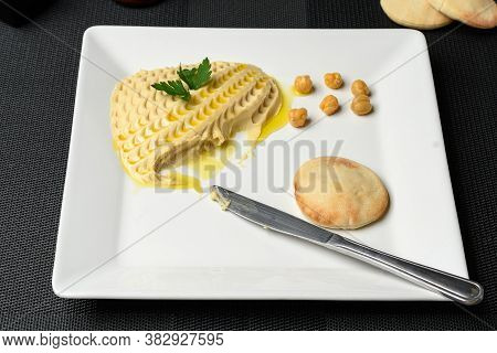 A Delight Of Arabic Cuisine, Homus And Syrian Bread On A White Plate