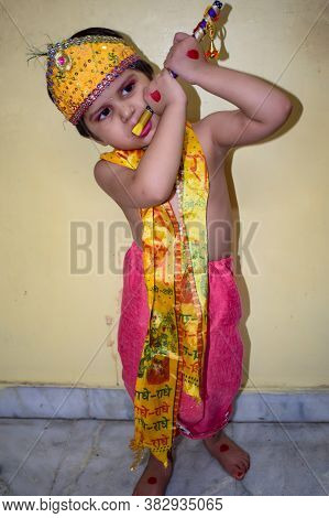 Cute Indian Kid Dressed Up As Little Lord Krishna On The Occasion Of Radha Krishna Janmastami Festiv