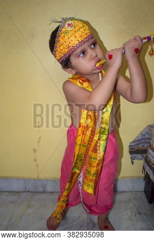Cute Indian Kid Dressed Up As Little Lord Krishna On The Occasion Of Radha Krishna Janmastami Festiv