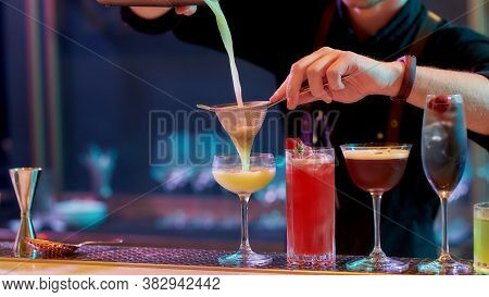 Fresh Up Your Night. Close Up Of Hands Of Male Bartender Pouring, Mixing Ingredients While Making Co