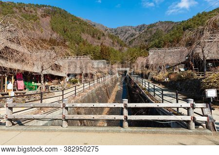 Yamanashi, Nenba, Lake Saiko, Japan - February 29, 2020: Thatched Roof Houses On The Edge Of A Dry R