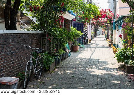Seoul,south Korea-may 2020: Bicycle Parking At The Alley Way With Rose Tunnel At The Background