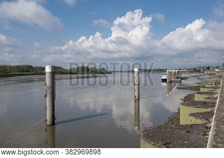 Tielrode, Belgium, Peaceful Landscape With The Durme River And The Landing Stage For The Ferry