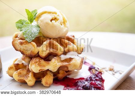 Closeup Of Waffles And Vanila Ice Cream With Raspberry Sauce On Dish, Dessert In The Restaurant (sel