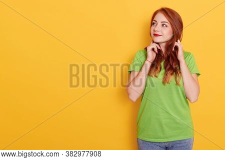 Photo Of Lovely Ginger Woman Looking Aside, Looks With Interesting Expression, Has Wavy Red Hair, We