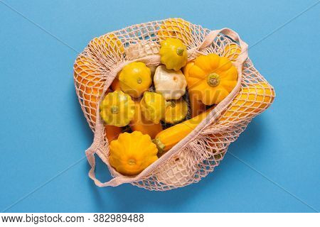 Fresh Harvest Of Zucchini And Pattypan Squash, Yellow Squash And Pattison In A Food Grid On Blue Bac