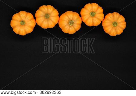 Lots Of Small Pumpkins On A Black Background.autumn Top Border Banner Made Of Orange Pumpkins And Au