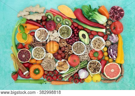Superfood for a healthy vegan diet including herbs used in natural and chinese herbal medicine with foods high in antioxidants, anthocyanins, vitamins, minerals, protein, omega 3 and fibre. Flat lay.