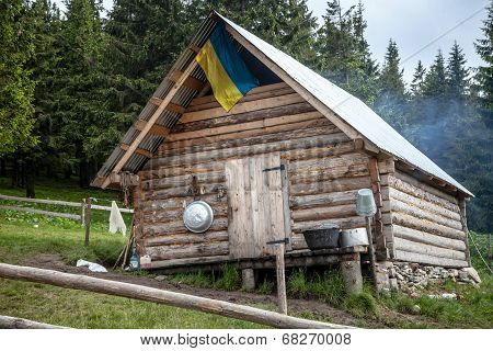 Wooden Kolyba Hut With A Ukrainian Flag