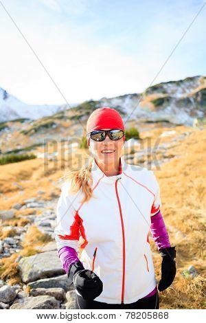 Happy Woman Running In Mountains On Winter Fall Sunny Day