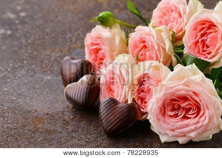 chocolate candy hearts and pink roses for Valentine's day holiday
