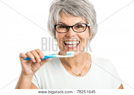 Portrait of a happy old woman brushing her teeth