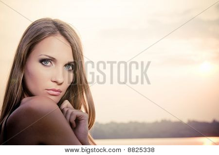 Woman In Dark Dress In The Beach