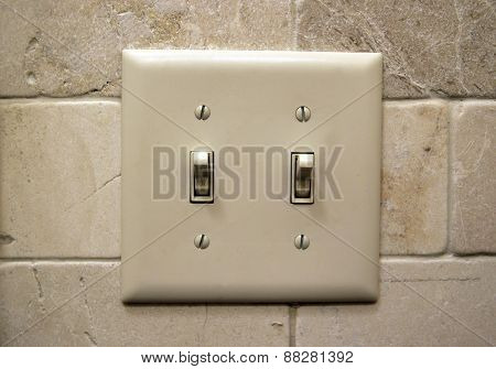 Light switch on a wall in a home.