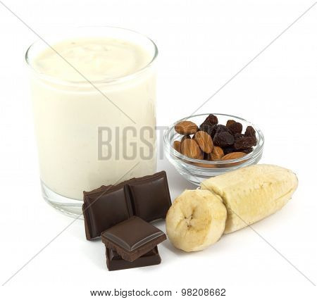 Yogurt with banana, chocolate, almonds and raisins isolated on white