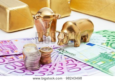 Golden Bear, Bull Figurines With Euro Coins  Gold Bars On Fanned Euro Notes