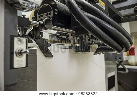 detailed view of a sheetfed offset printing machine filled with blank paper