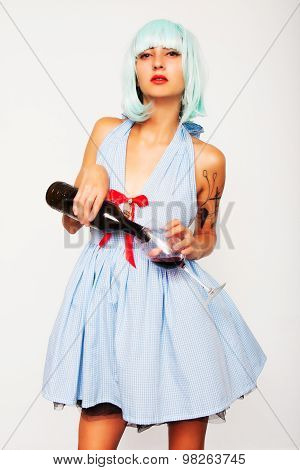 Attractive model woman pouring wine in a glass