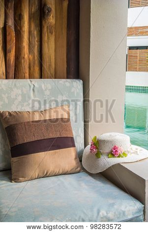 Cushion And Hat At Balcony Poolside.