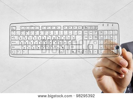 Close up of hand darwing computer keyboard with marker 