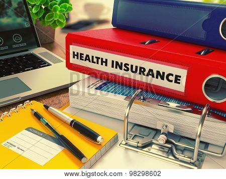 Red Office Folder with Inscription Health Insurance.