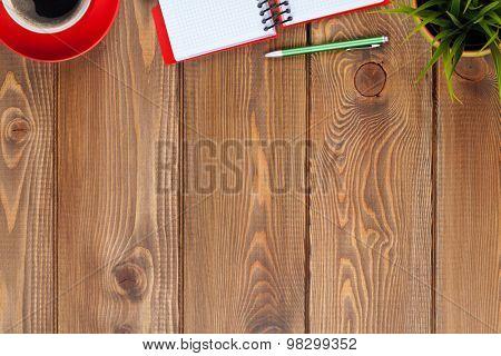 Office desk table with supplies, coffee cup and flower. Top view with copy space