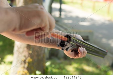 Cleaning the gun. Hands cleaning the gun.