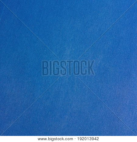 Texture of a blue worn cloth. The fabric is blue. Wiped fabric structure.