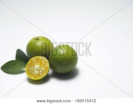 Three limes, whole and halved