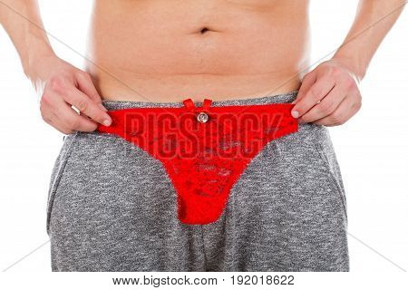 Picture of a young man half naked holding a red female thong  