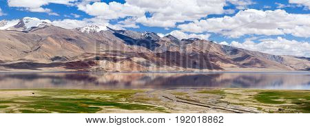 Tso Moriri mountain lake and the mountain river floodplain panorama in the Himalayas with fantastic reflections of the mountains and sky in the lake (Ladakh northern India)