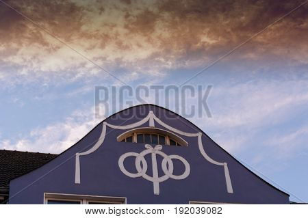 House gable residential house facade with stucco work.