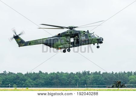 BERLIN GERMANY - JUNE 01 2016: Landing helicopter NH90 of the German Army. Demonstrative performance. Exhibition ILA Berlin Air Show 2016