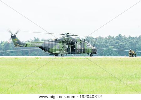 BERLIN GERMANY - JUNE 01 2016: Landing helicopter NH90 of the German Army. Demonstrative performance. Exhibition ILA Berlin Air Show 2016