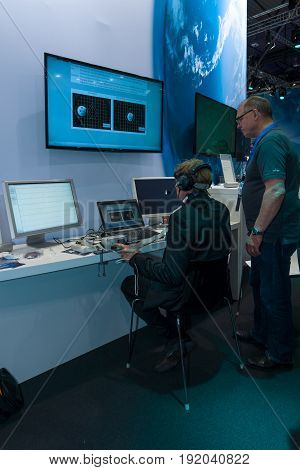 BERLIN GERMANY - JUNE 01 2016: The stand of German Aerospace Center (DLR). The simulator remote control technology. Exhibition ILA Berlin Air Show 2016.