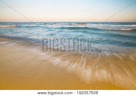 beach and beautiful tropical sea. beautiful seascape and sun on blue sky background. Long exposure