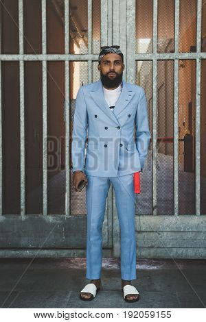 MILAN ITALY - JUNE 19: Fashionable man poses outside Armani fashion show building during Milan Men's Fashion Week on JUNE 19 2017 in Milan.