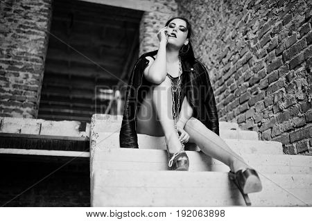 Brunette Plus Size Sexy Woman, Wear At Black One Piece And Leather Jacket,with Chain At Abadoned Pla