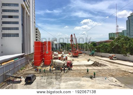 BANGKOK THAILAND 17 JUN 2017: Workers fabricating column timber formwork and reinforcement bar at the construction site near the Phayathai BTS station