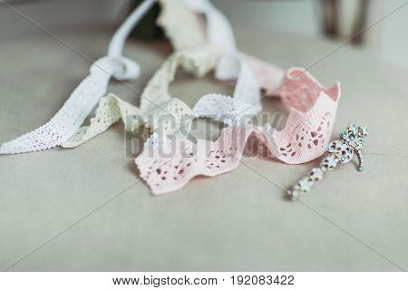 Wedding accessories: boutonniere and bride's bouquet on the chair