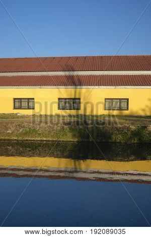 Cycling lane along the Naviglio Pavese from Pavia to Milan (Lombardy Italy) in the springtime. Building