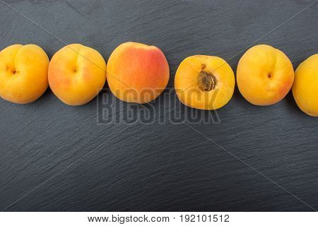 Ripe Apricot On Black Background Of Slate Or Stone